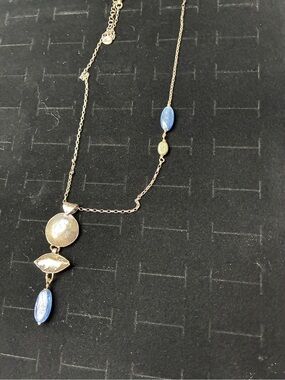 Delicate Blue Stone Pendant Necklace in sterling silver.
